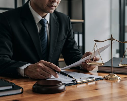 lawyer-working-document-with-scales-justice